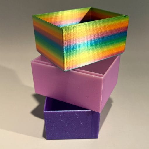 Three Nock Deck Blocks stacked. Rainbow at the top, sparkly pink and purple below.